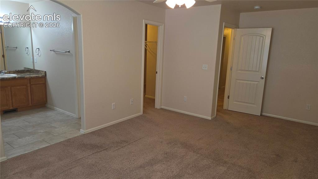 Image 6 of 23: Primary bedroom with private bath and walk in closet