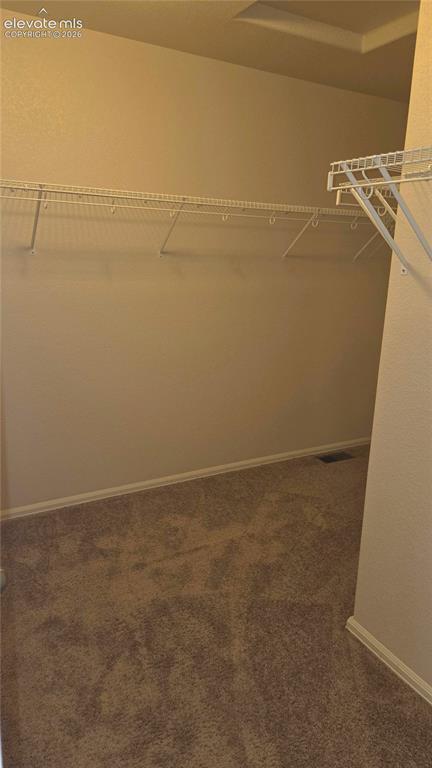 Image 8 of 23: Walk in closet in primary bedroom