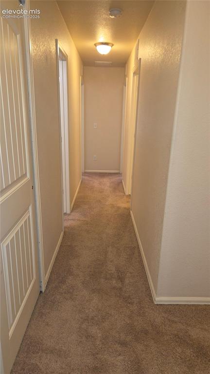 Image 9 of 23: Upper level hall to secondary bedrooms, bathroom and laundry room