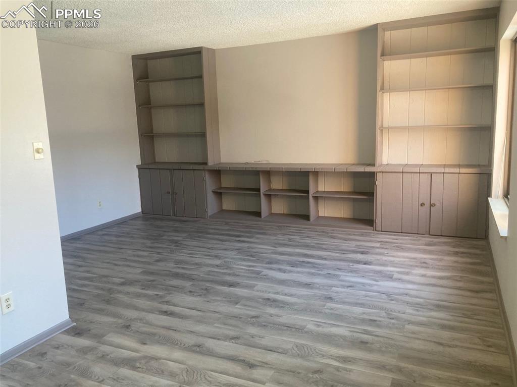 Image 10 of 19: built in bookshelves and TV area