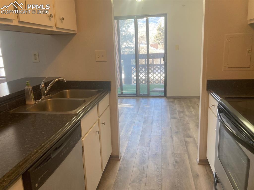 Image 3 of 19: View from kitchen to dining area and walk out to deck