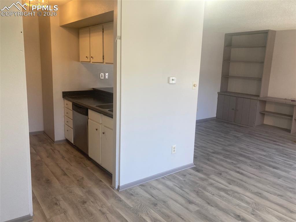 Image 7 of 19: View from dining area through kitchen to iving room
