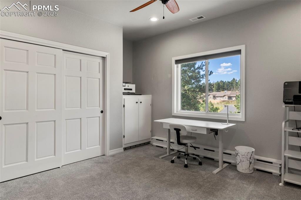 Image 23 of 46: Office with light carpet, a ceiling fan, baseboard heating, and recessed li