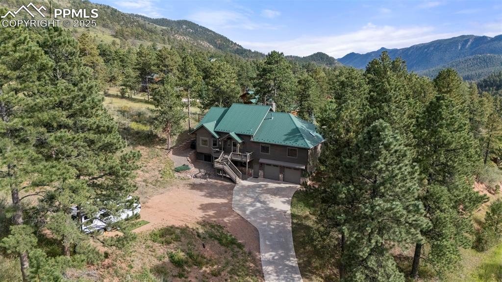 Image 41 of 46: Aerial view of property and surrounding area featuring a heavily wooded are