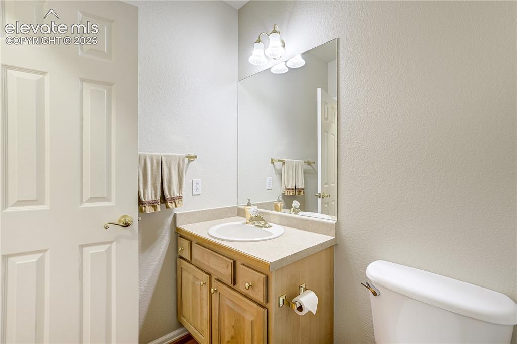 Image 23 of 48: 1/2 bath off kitchen across from laundry room