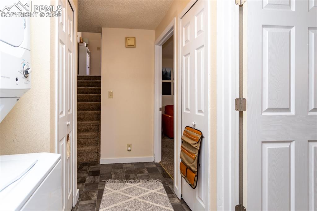 Image 28 of 39: Laundry is on the lower level.  Occupied unit 1905