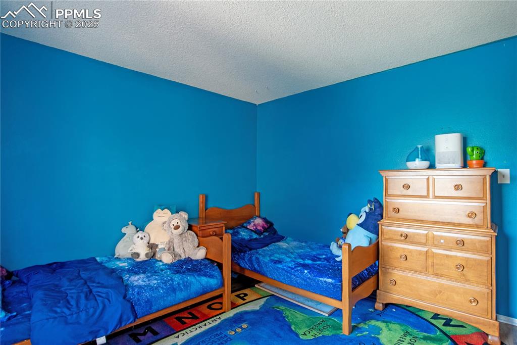 Image 15 of 29: Bedroom with a textured ceiling