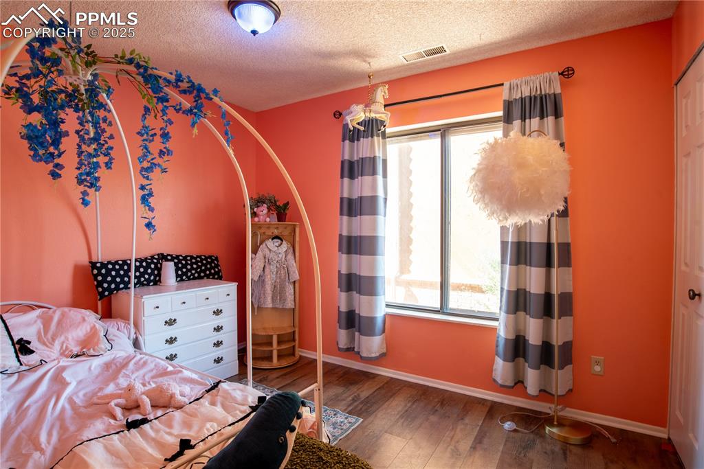 Image 18 of 29: Bedroom with a large window