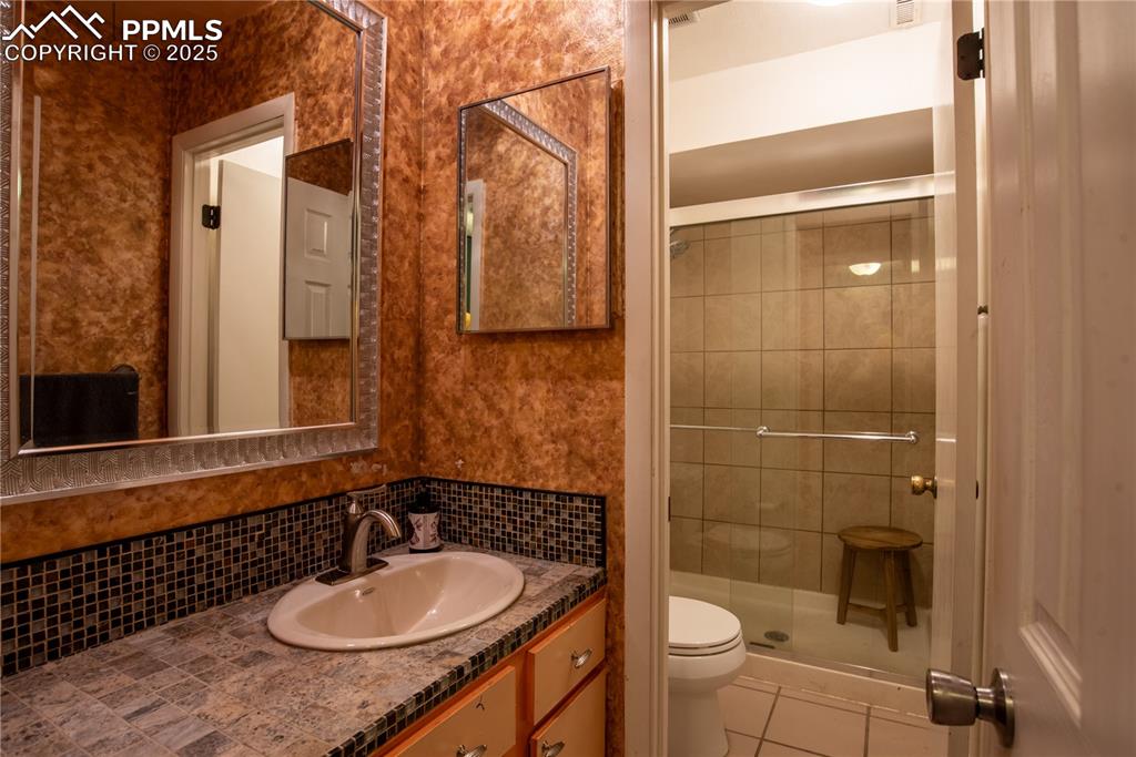 Image 22 of 29: Full bath with walk-in shower 