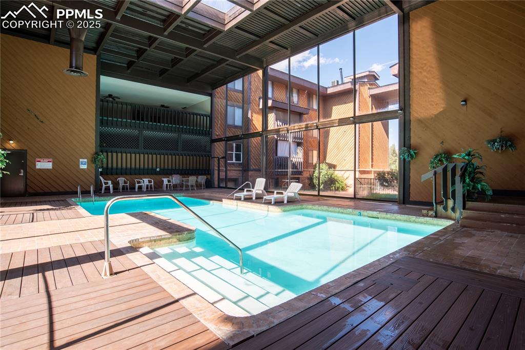 Image 26 of 29: Indoor heated community pool and hot tub