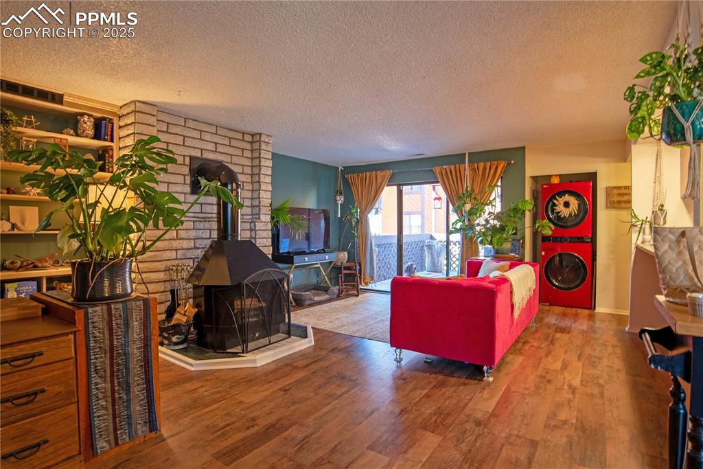 Image 5 of 29: Living area featuring LVP flooring throughout, and in-unit stacked washer/d