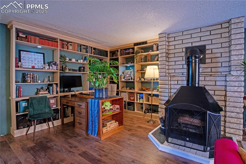 Image 6 of 29: Office area, with built-in bookshelves & a wood-burning fireplace 