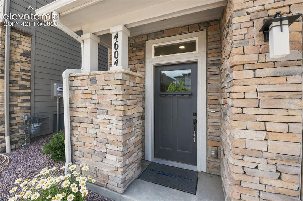 Image 2 of 31: Front Door with Covered Patio