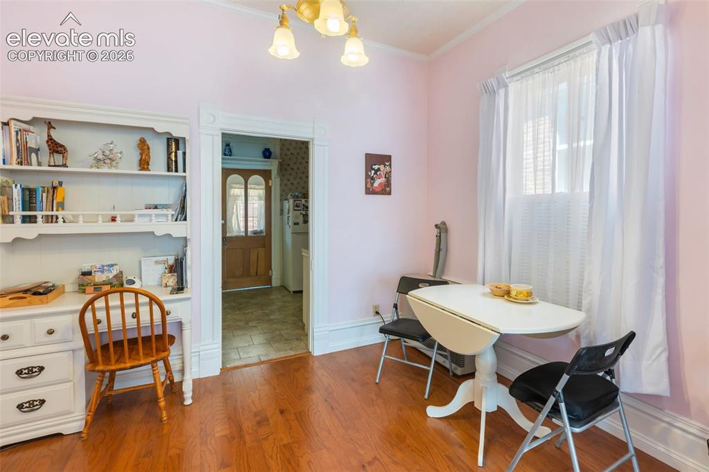 Image 14 of 29: Warm wood tones and easy kitchen access make this the perfect dining room.