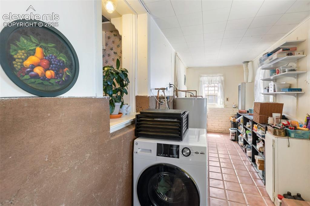 Image 20 of 29: Extensive enclosed patio and laundry space with an extra storage closet. Wa