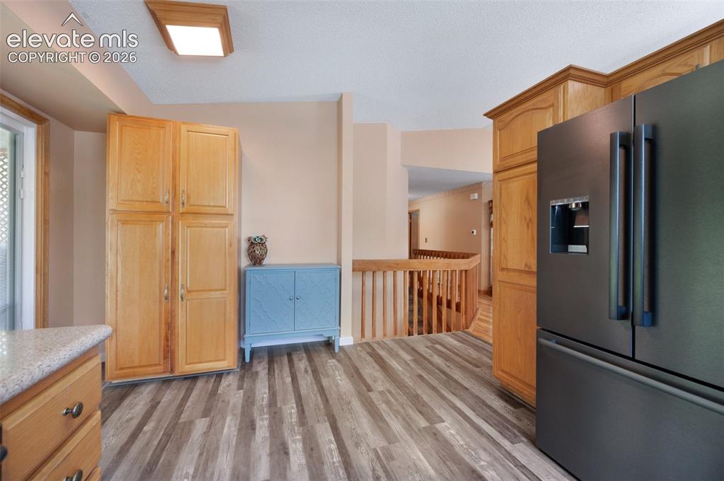 Image 14 of 50: Kitchen featuring stainless steel refrigerator with ice dispenser, light wo