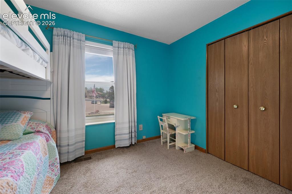 Image 23 of 50: Bedroom with carpet, baseboards, and a closet