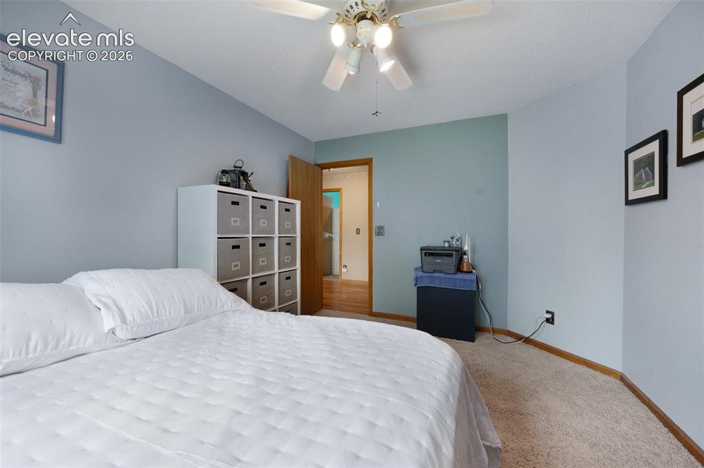 Image 27 of 50: Carpeted bedroom featuring baseboards and a ceiling fan