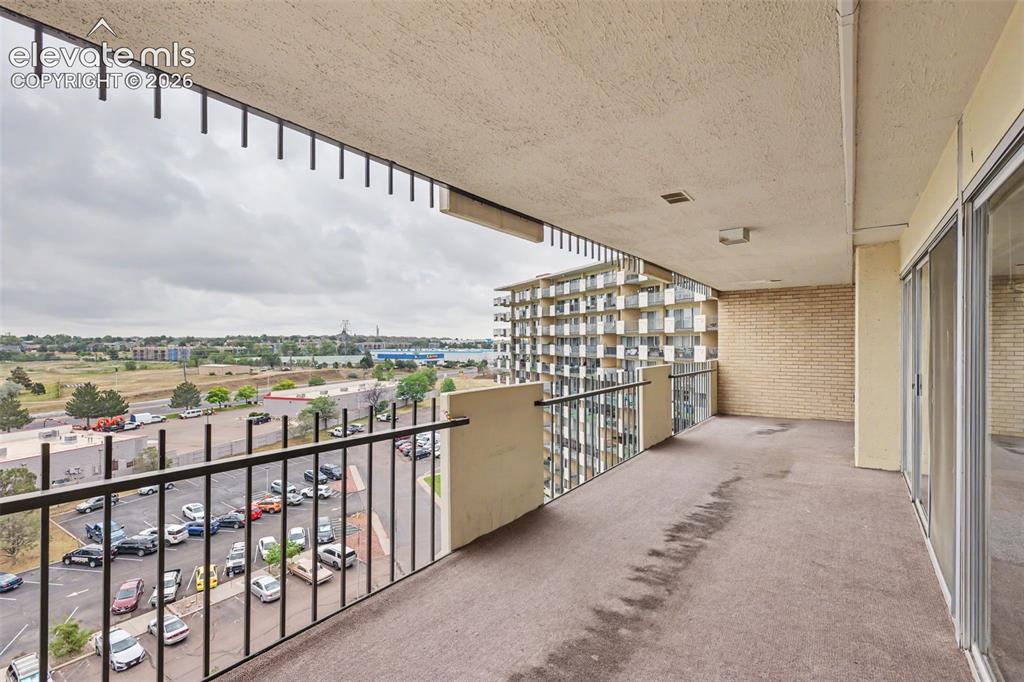 Image 23 of 25: The large covered balcony provides the home
