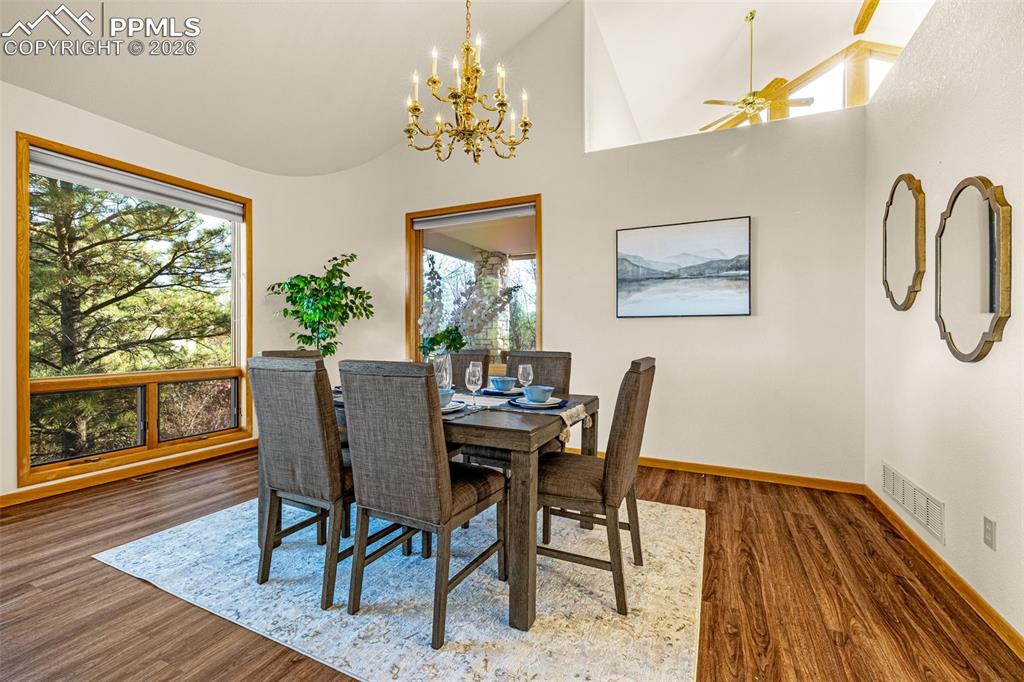 Image 11 of 47: Dining space featuring healthy amount of natural light, suspended lighting,