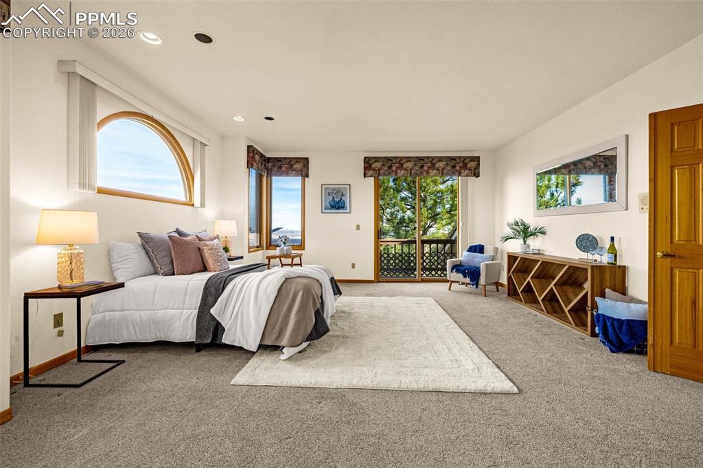 Image 23 of 47: Bedroom featuring access to outside, carpet floors, multiple windows, and r
