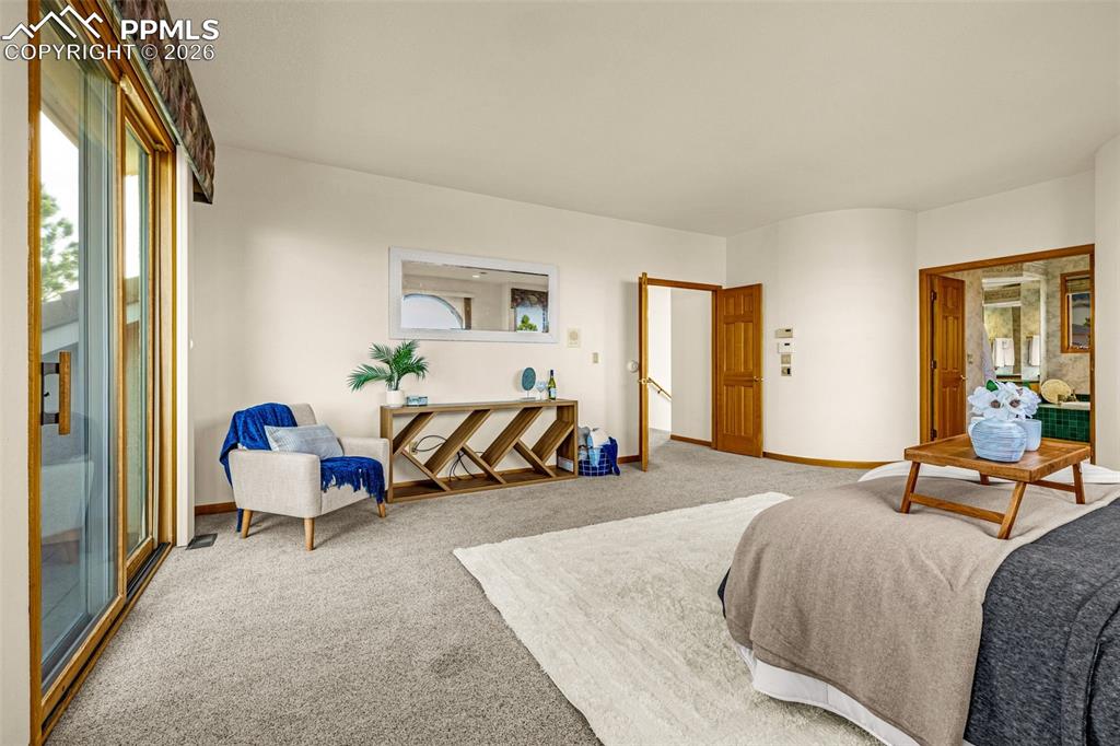 Image 25 of 47: Bedroom with light carpet, multiple windows, and access to outside