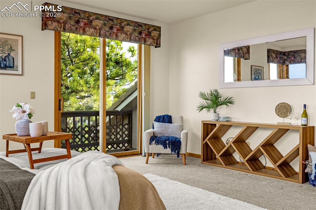 Image 26 of 47: Bedroom featuring carpet flooring, multiple windows, and access to outside
