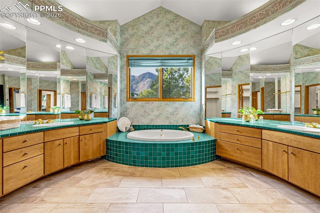 Image 27 of 47: Full bath featuring recessed lighting, two vanities, and a bath