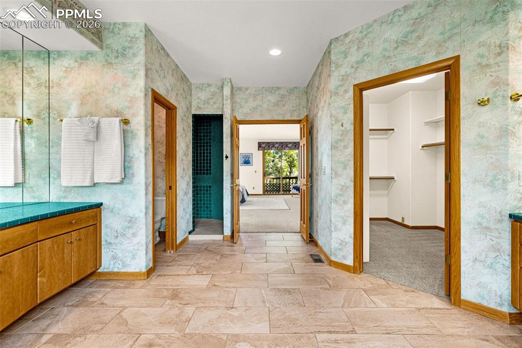 Image 29 of 47: Full bathroom featuring vanity, recessed lighting, light stone finish floor
