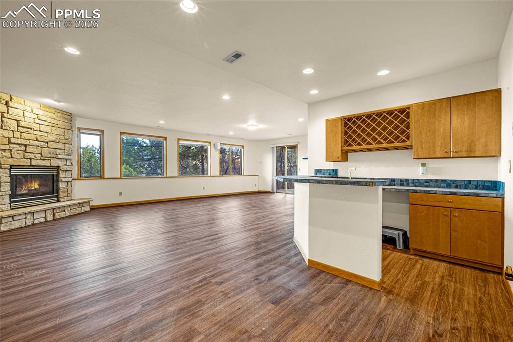 Image 33 of 47: Kitchen featuring open floor plan, dark countertops, wood finish cabinets, 