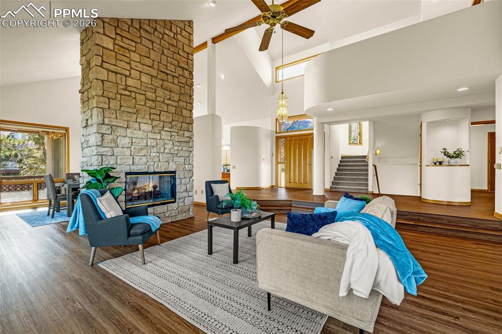 Image 7 of 47: Living area with vaulted ceiling, dark wood-style flooring, ceiling fan, a 