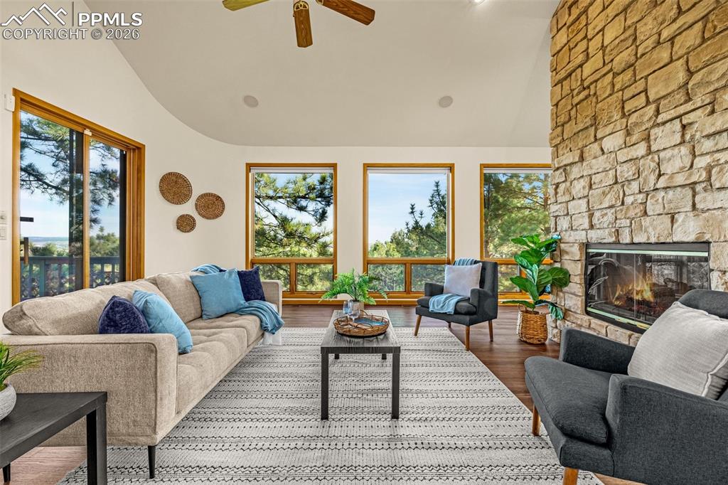 Image 9 of 47: Living room with vaulted ceiling, a ceiling fan, wood finished floors, and 