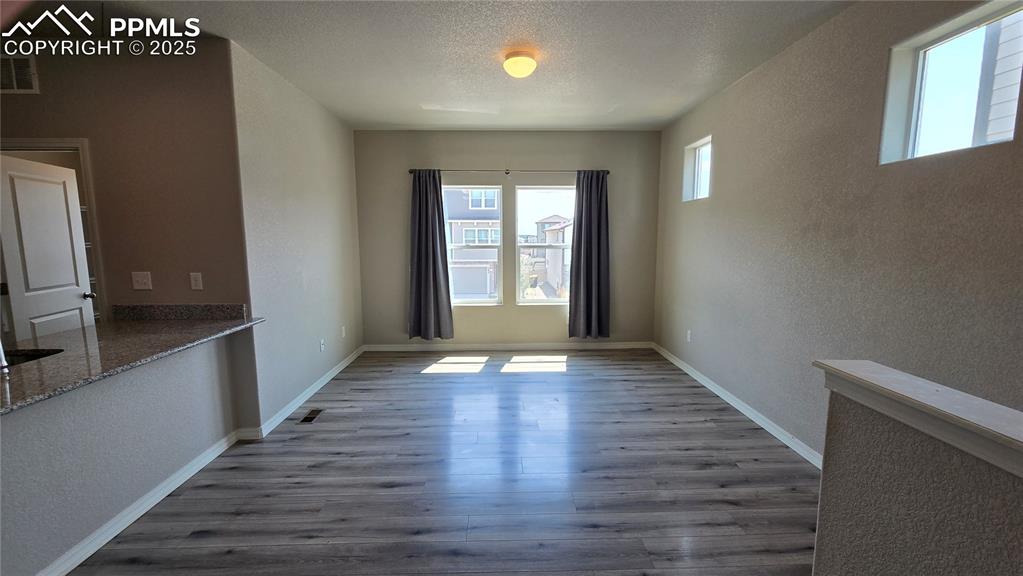 Image 11 of 29: Unfurnished living room with wood-style  floors.