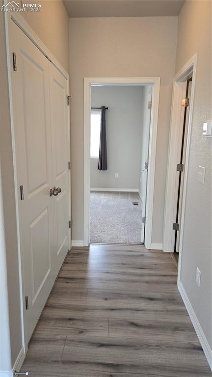 Image 20 of 29: Hallway to upper level bedroom and bathroom.  HVAC closet on left.