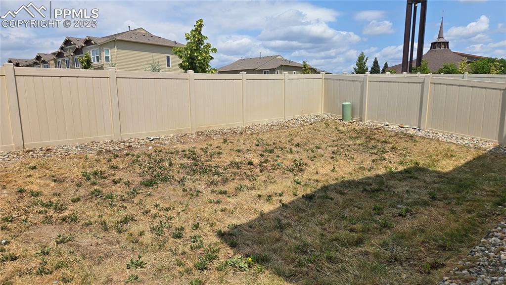 Image 28 of 29: Fenced backyard featuring a residential view