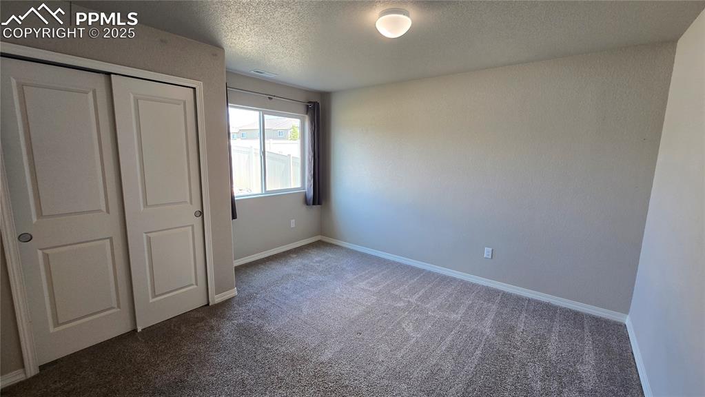Image 5 of 29: Main level bedroom featuring carpet floors. 