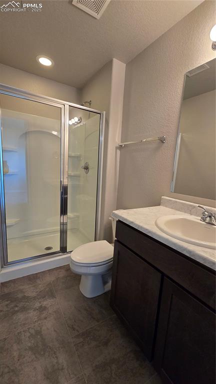 Image 8 of 29: 3/4 bathroom featuring vanity, a stall shower, and recessed lighting