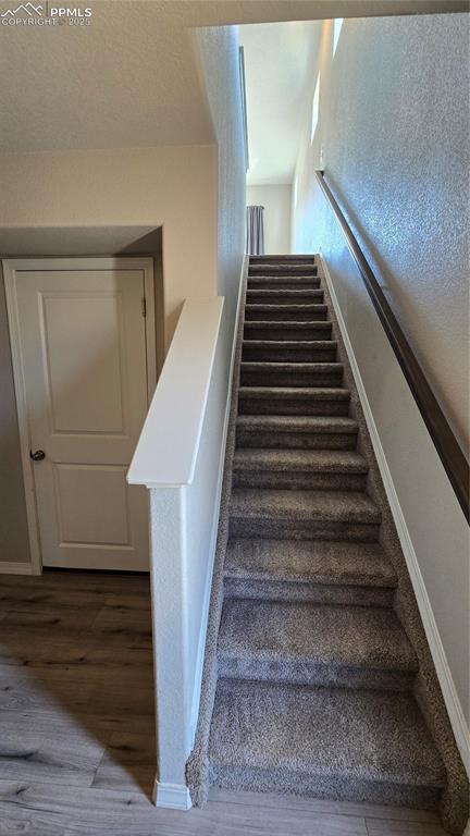 Image 9 of 29: Stairs leading to upper level from entry.