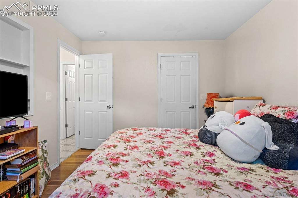 Image 15 of 21: Bedroom featuring wood finished floors and baseboards