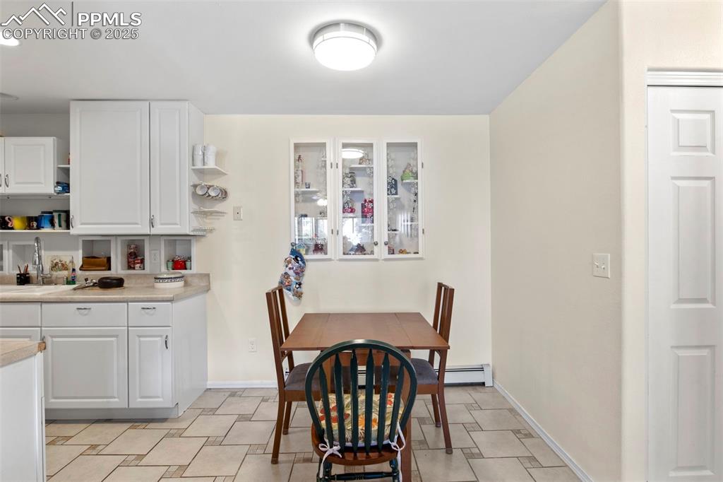 Image 6 of 21: Dining room featuring baseboards and baseboard heating