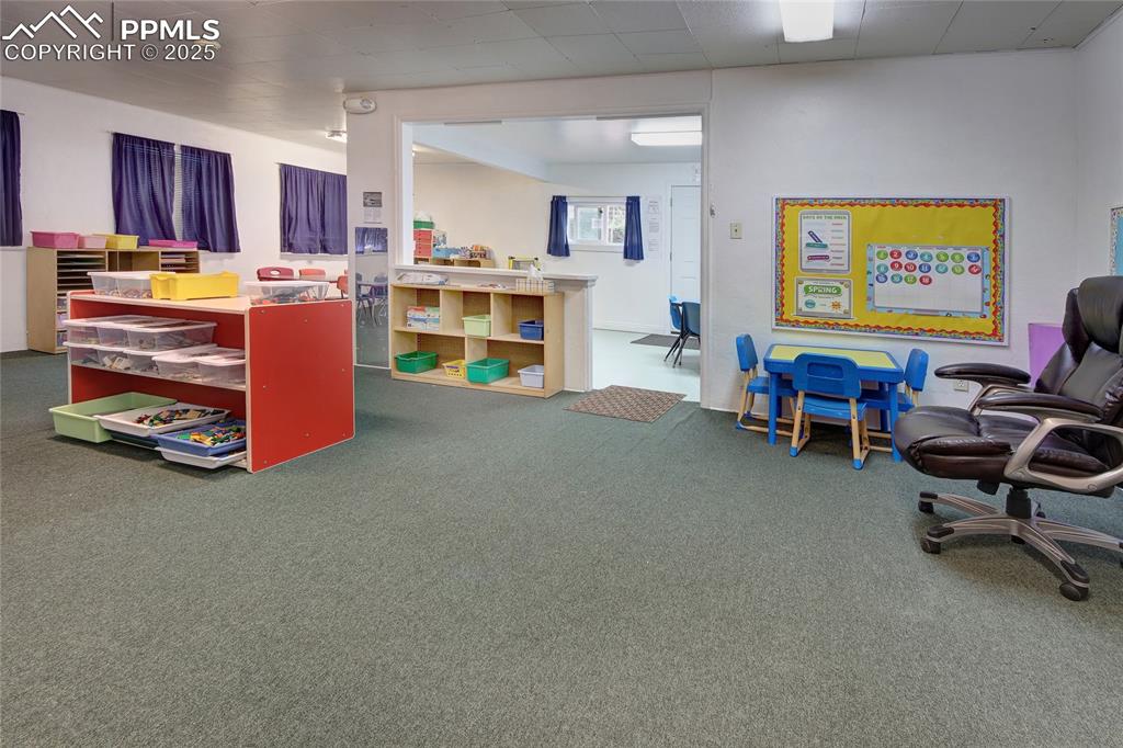 Image 14 of 34: Rec room with dark colored carpet