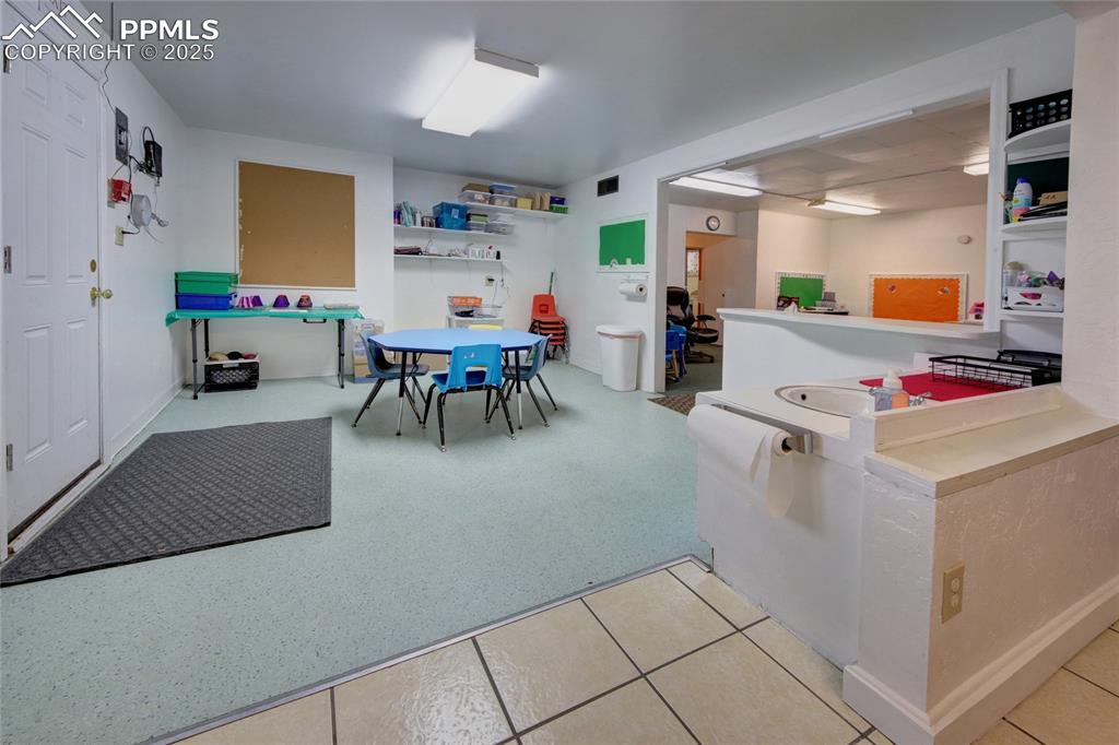 Image 17 of 34: Rec room with light tile patterned floors