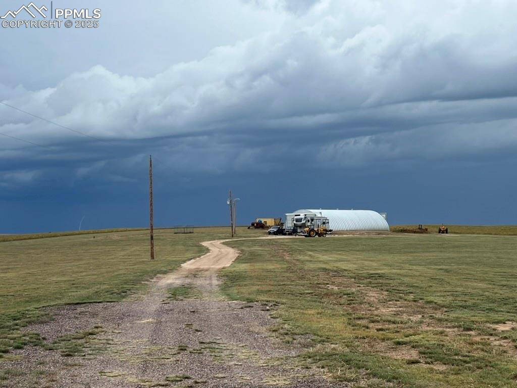 Image 20 of 31: View of dirt / gravel driveway with an outbuilding and a view of rural / pa