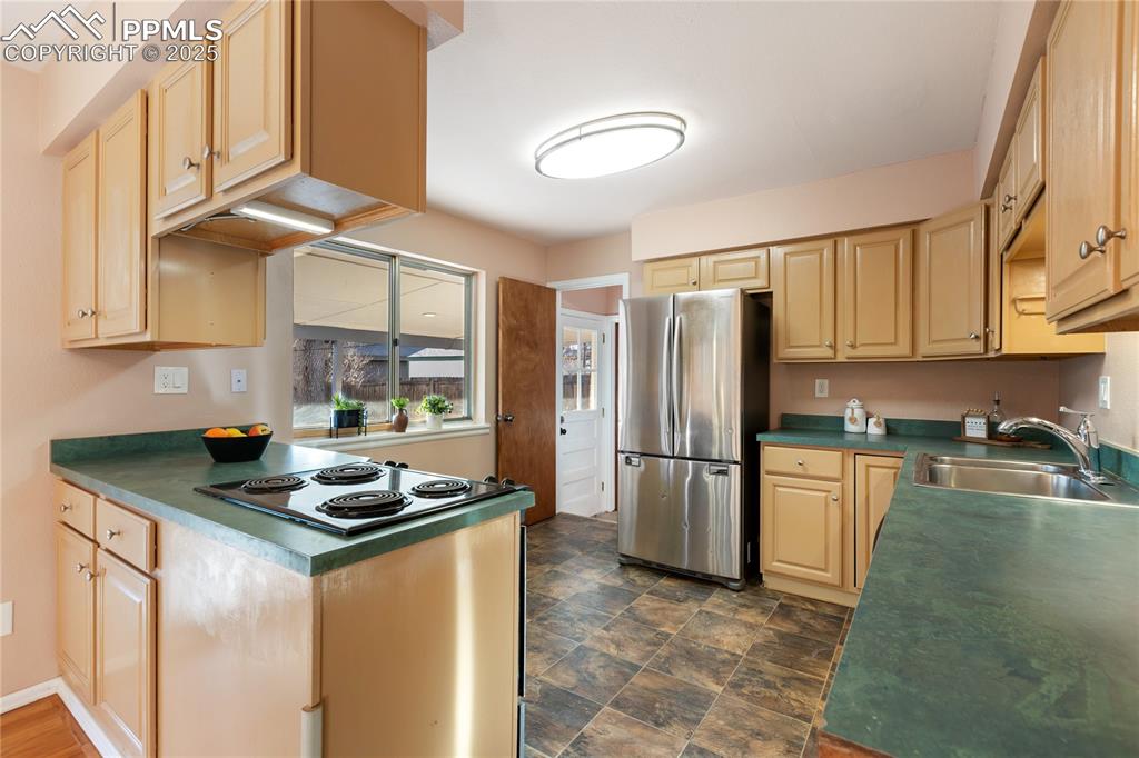Image 16 of 38: Kitchen features stainless steel appliances.