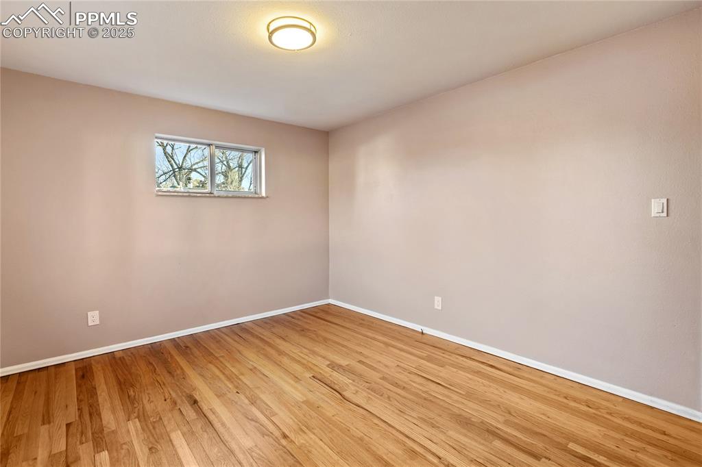 Image 24 of 38: One of 3 bedrooms on the main level - refinished hardwood flooring