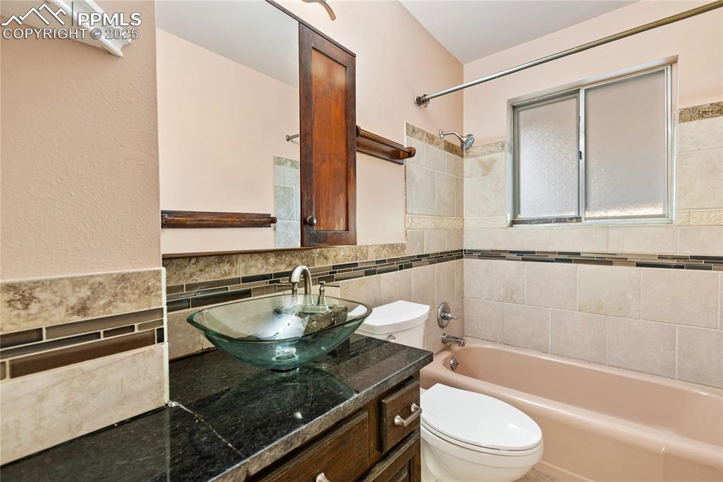 Image 28 of 38: Main level hall bathroom