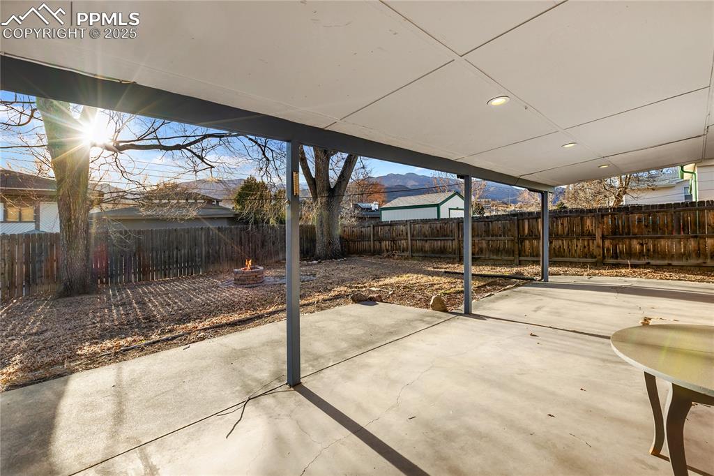 Image 6 of 38: Large covered back patio with mountain views.