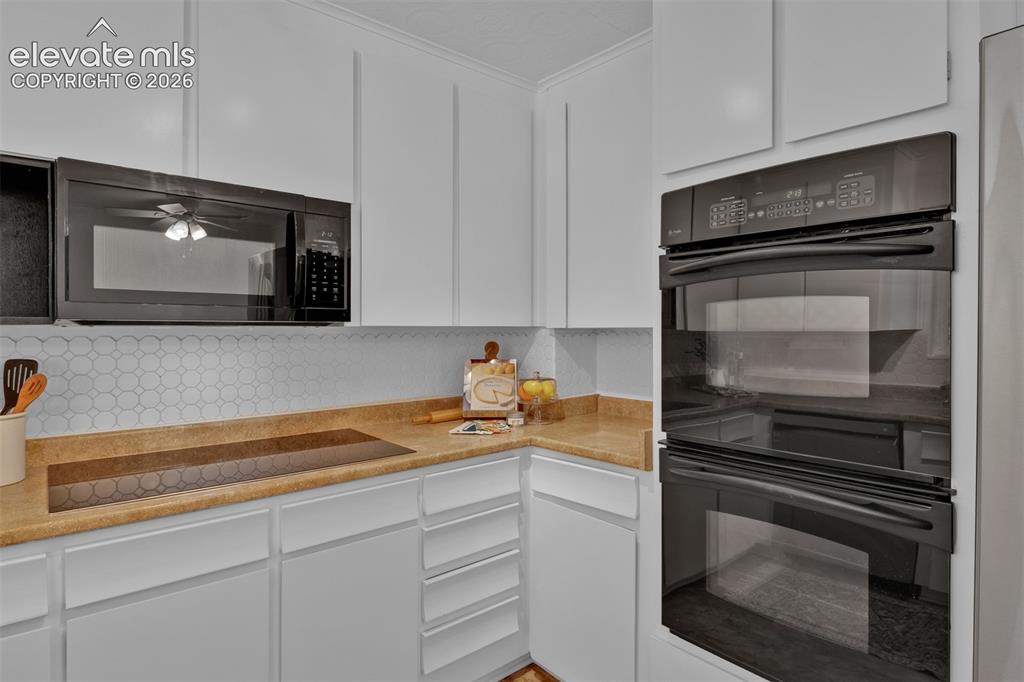 Image 13 of 40: Opposite view of the kitchen into breakfast nook. Doorway leads to the back