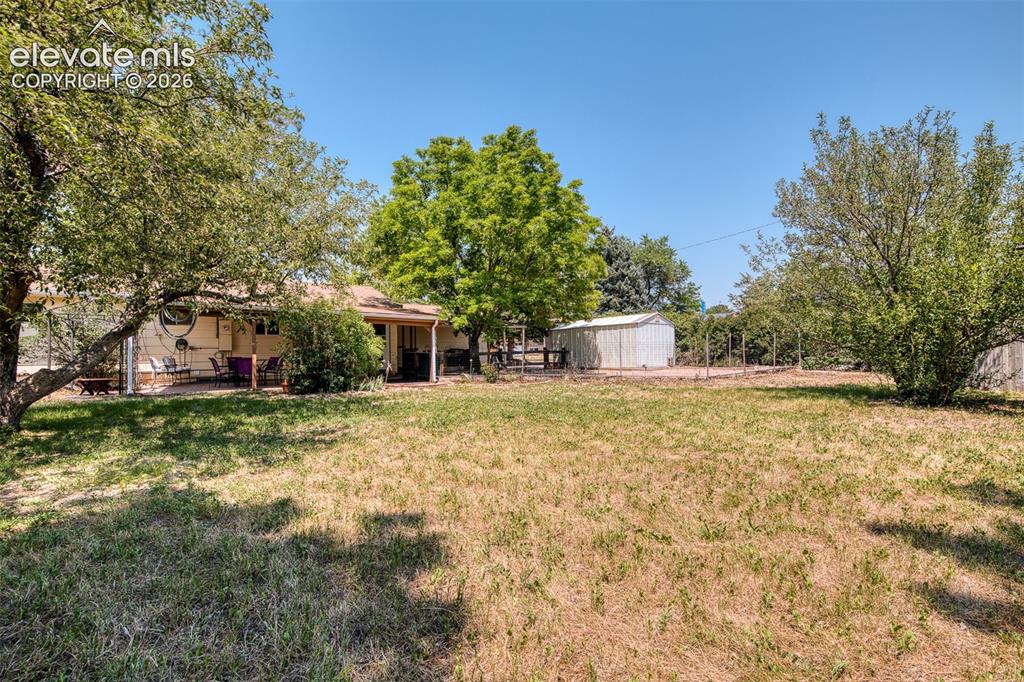 Image 41 of 45: Large corner lot - fully fenced, mature fruit trees, two large storage shed