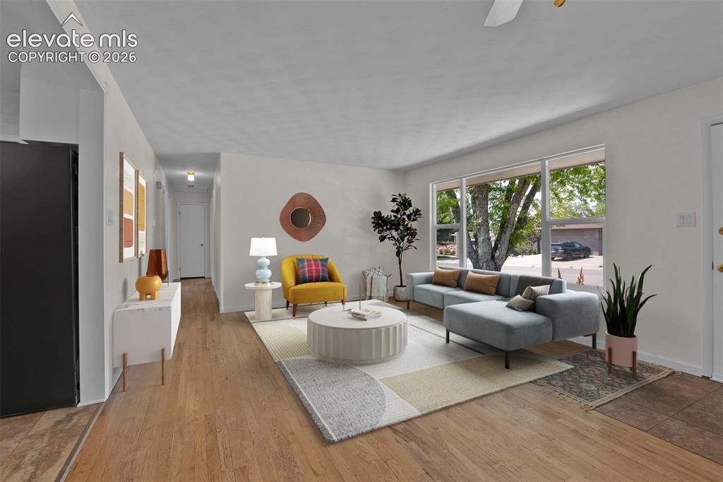Image 6 of 40: Fresh paint, large updated windows and original hardwood floors greet you a